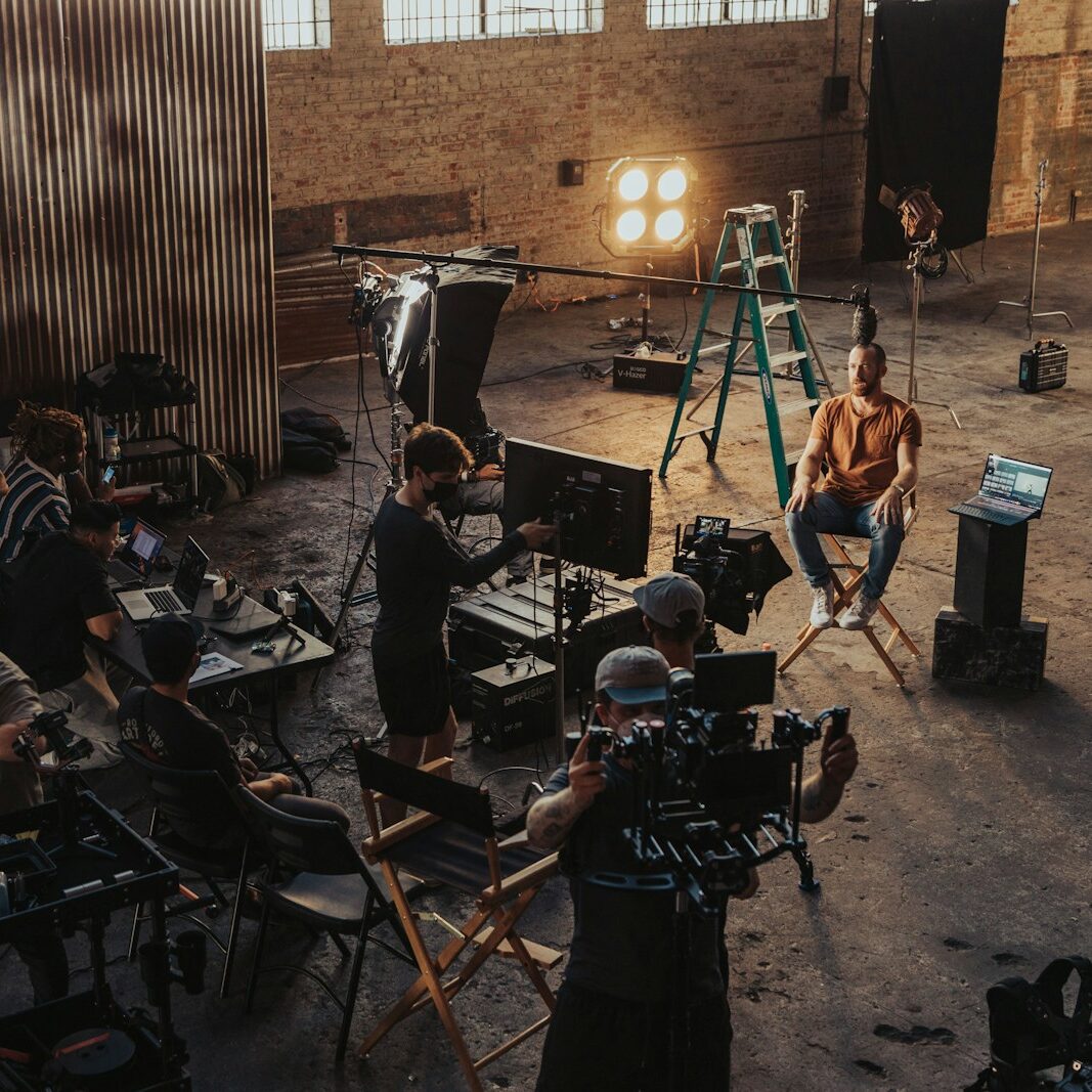 a group of people standing around a camera set up